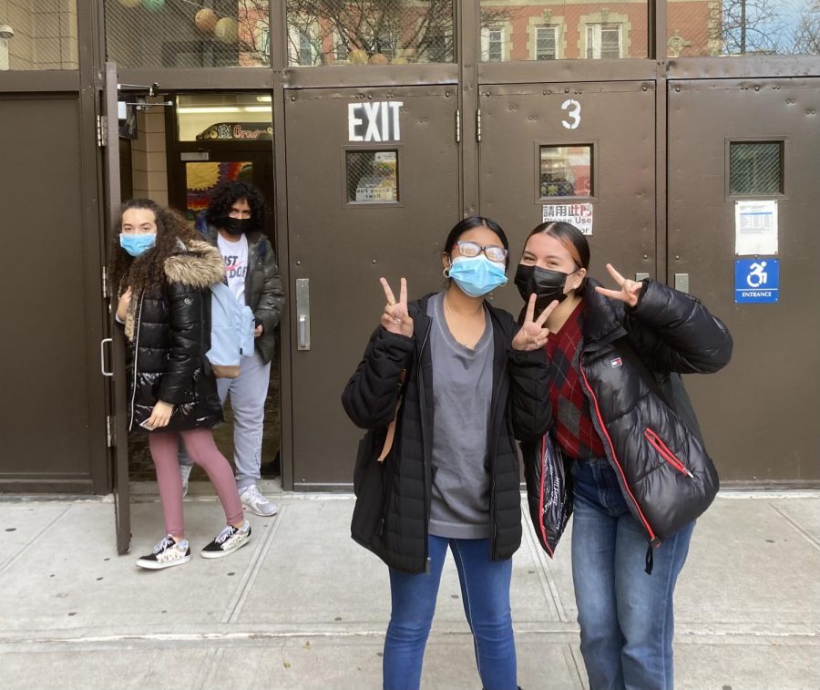 Masked Pace students at the Hester Street entrance to the building.