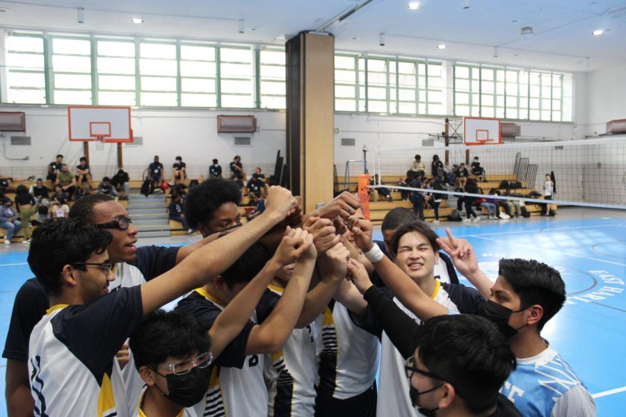 The team in a huddle bringing the energy to the game to close it out.