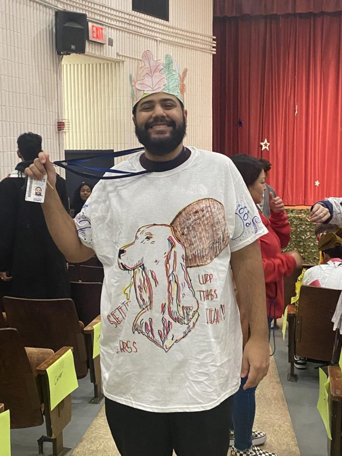 Mr. Suriel models a T-shirt designed by his very own advisory for PaceGiving. On the shirt, students drew a setter, Paces mascot, with a glitch effect. Also, Mr. Suriel wears a crown made out of the leaves that his students colored in honor of Thanksgiving and the autumn season.