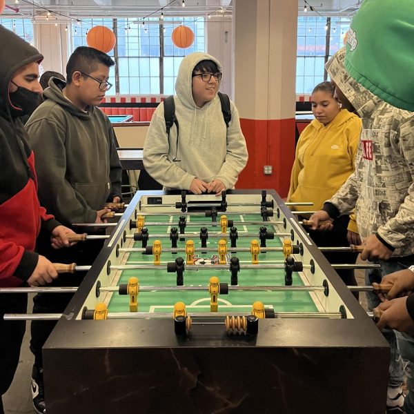 Sophomore students play foosball at an arcade in Industry City for an advisory trip before December break.