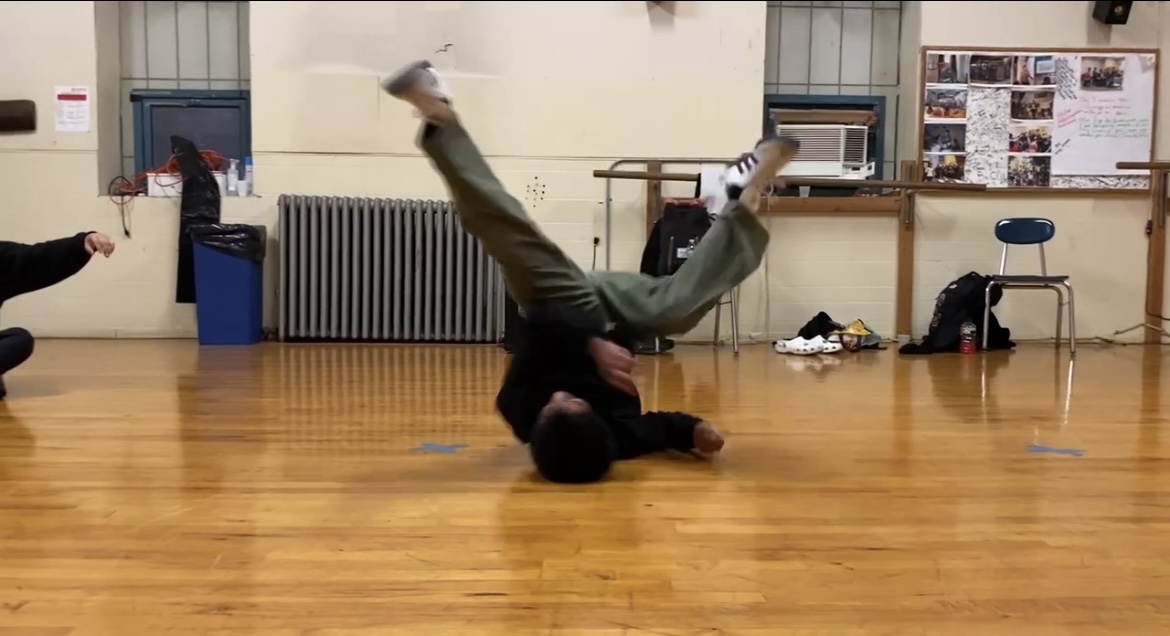 Joseph Landy heading into a windmill position during his dance practice after school.