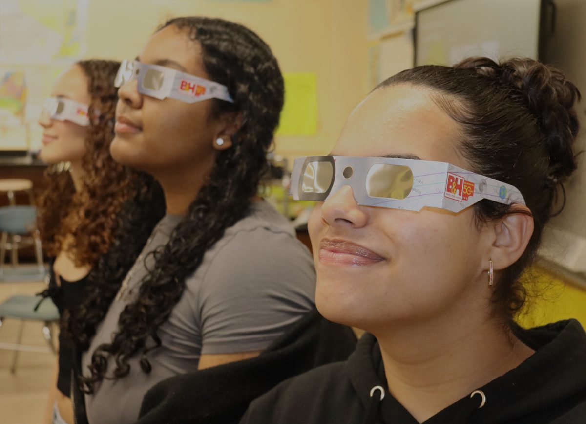 Seniors Serenity Seda, Naima Galeas and Valery Collado know that theyll need to wear special glasses provided by the school to safely witness the solar eclipse on April 8.