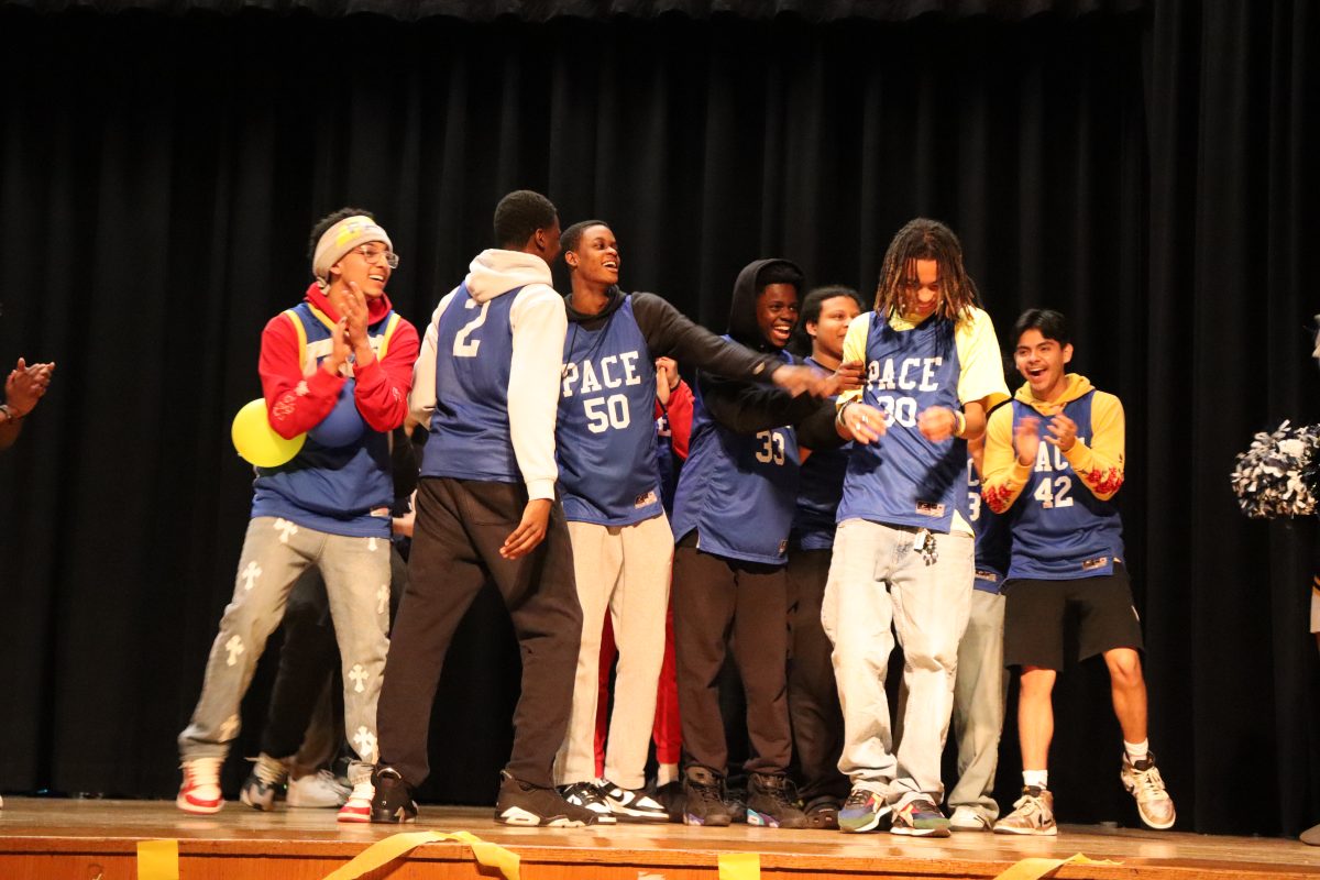 The boys basketball team got called up to the stage to represent.