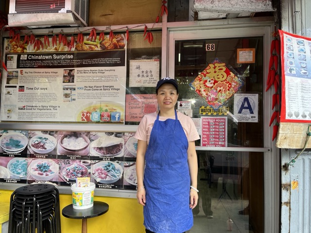 Wendy Lian proudly stands in front of Spicy Village, where students eagerly await their pepper chicken.