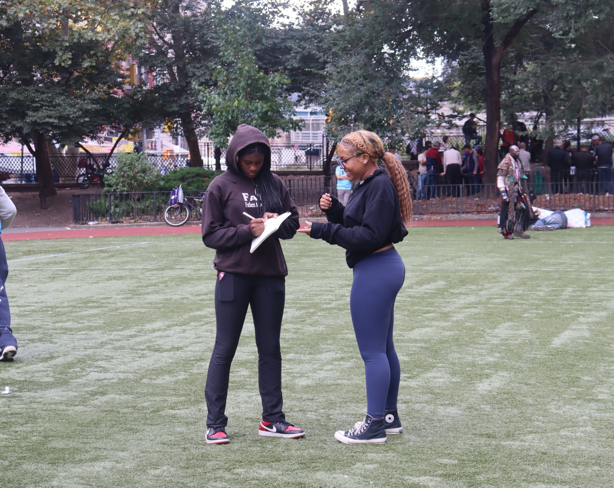 Amy Rojas talking with ninth grader, Vaeha Jackson, during flag football practice.