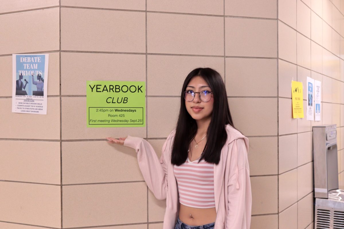 Camila Fuentes standing in front of the yearbook poster.