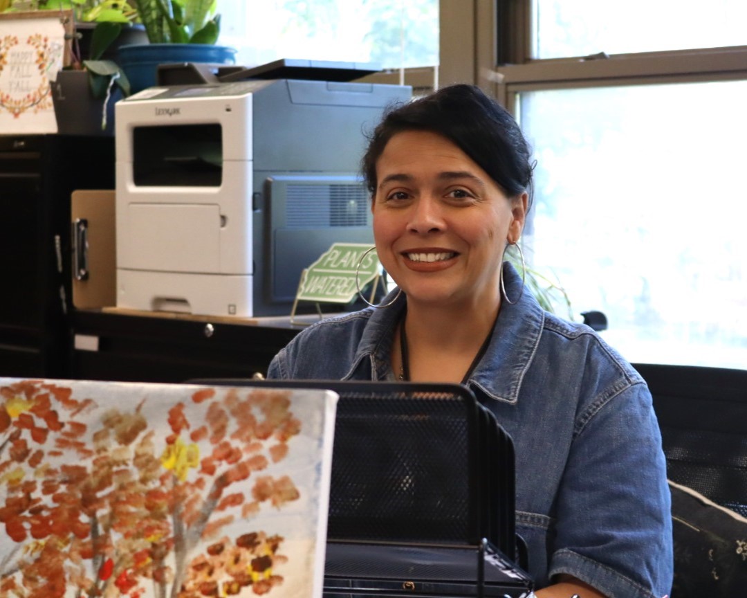 Y. Miranda flashes a smile while bookkeeping school records.