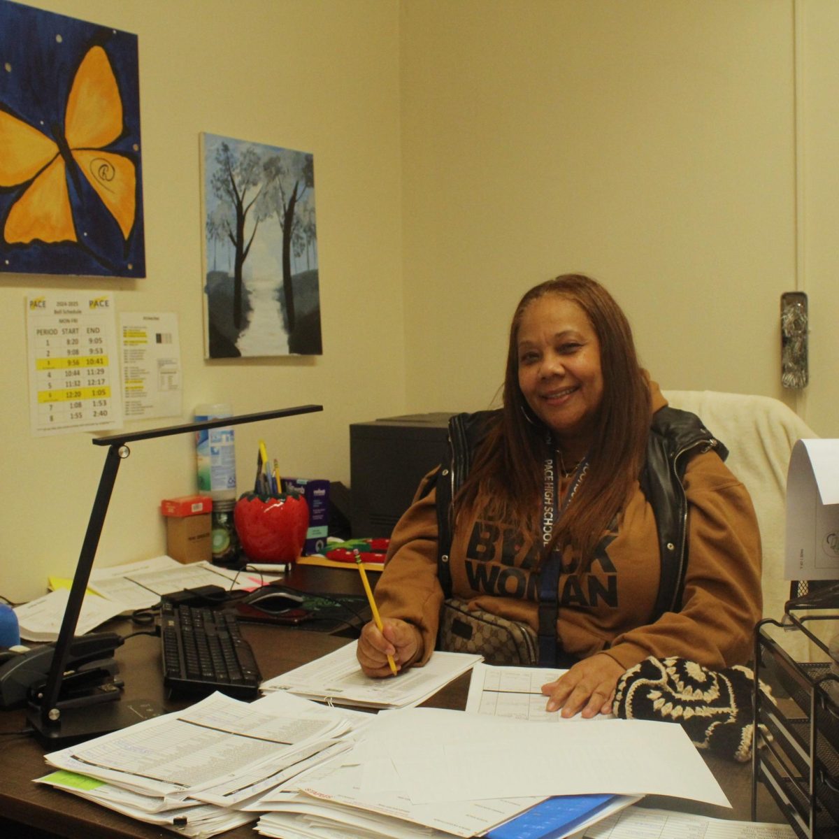 Ms. Knight checks over attendance records at her office on the fourth floor.