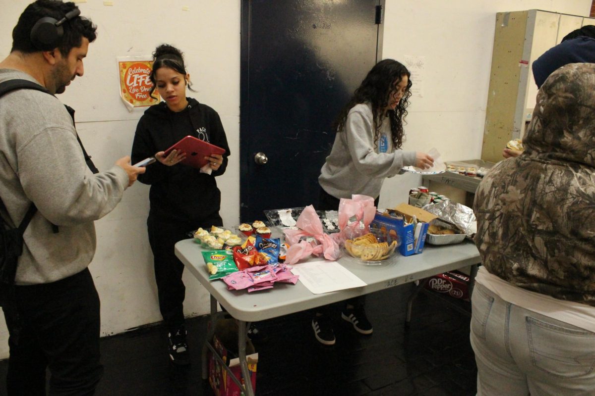 Members of Pace’s softball team having a bake sale to raise money for sports equipment and jerseys