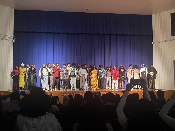 Students of all grades including staff members Ms. Ransome, Mr. Zoboi and Ms. Watkins pose for a group picture after their fashion runway.