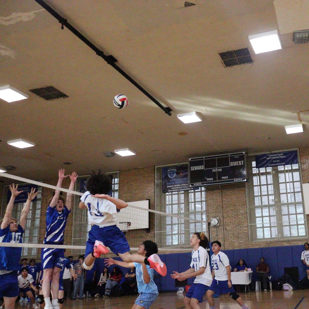Freshman Jeff Perez goes up to spike the ball against Seward Park during regular season.