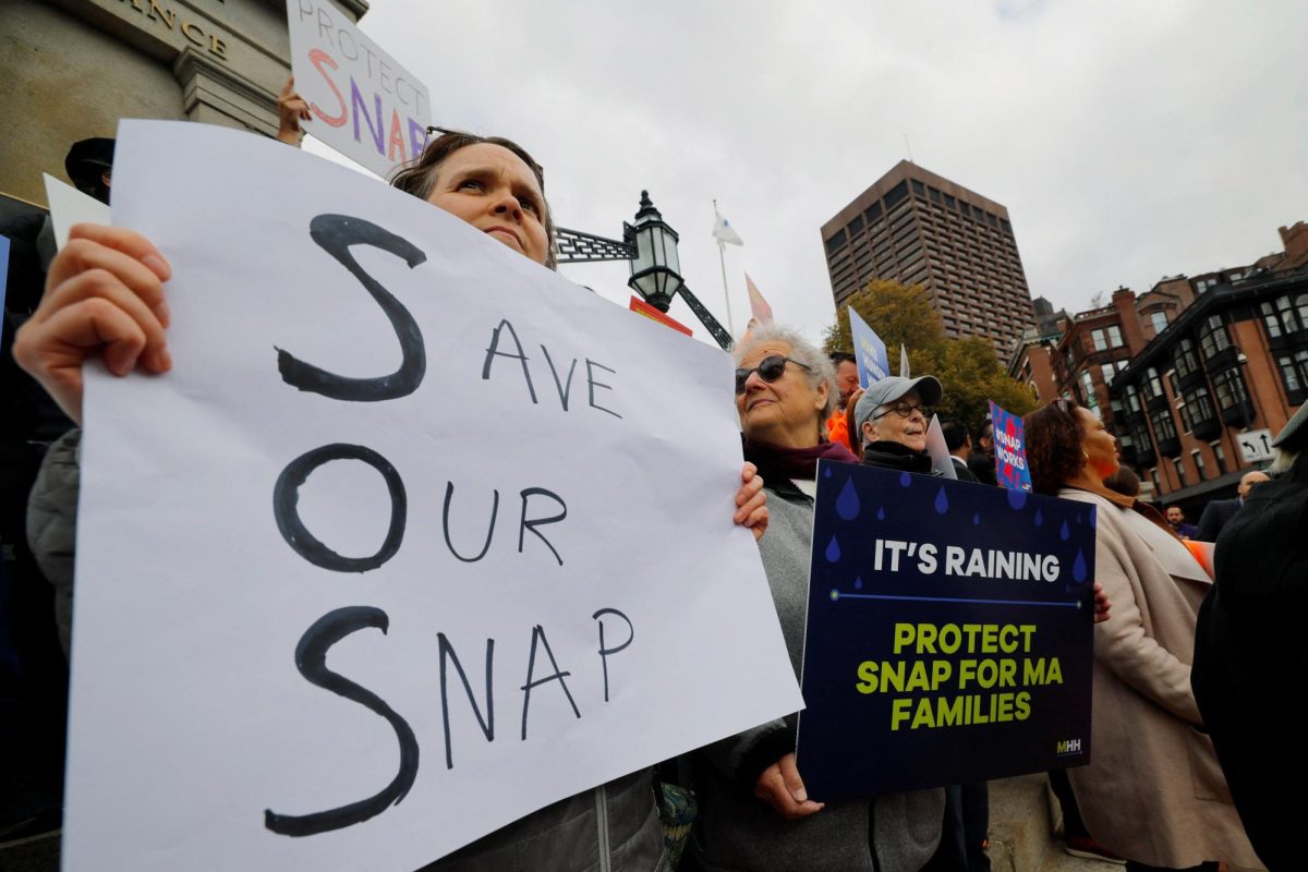 A woman holds a sign reading "Save Our SNAP," as food aid benefits will be suspended starting November 1 amid the ongoing U.S. government shutdown, during "A Rally for SNAP" on the steps of the Massachusetts Statehouse in Boston, Massachusetts, U.S., October 28, 2025. REUTERS/Brian Snyder