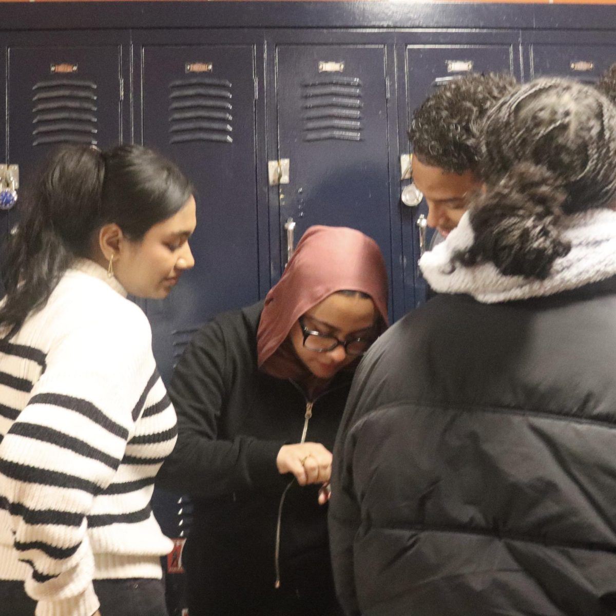 Sophomores Urmi, Mauri and Raida learn how to use the master lock.