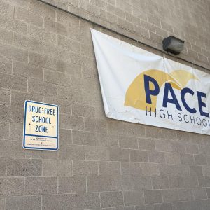 Sign stating PACE is a 'drug-free' school zone in front of school building.